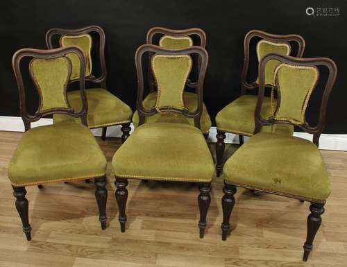 A set of six Victorian mahogany dining chairs, shaped backs with shield shaped splats, carved with