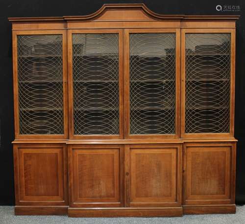 A regency design brake centre library bookcase, arched outswept cornice above four glazed doors