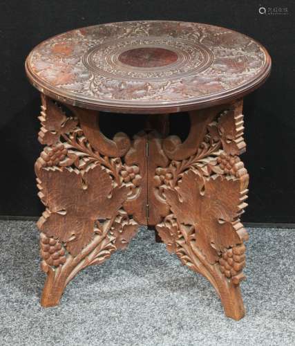 A small circular wine table, carved with fruiting vine, tripod base,45cm diameter, 46cm high