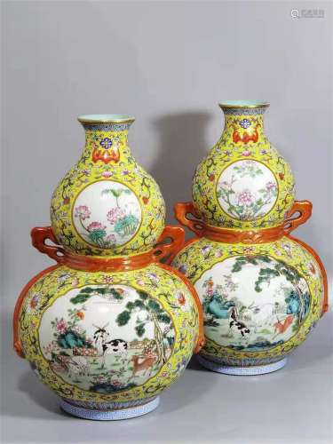A PAIR OF QING DYNASTY QIANLONG FAMILLE ROSE YELLOW GROUND FLOWER OF LONGEVITY AND HAPPINESS GOURD BOTTLES