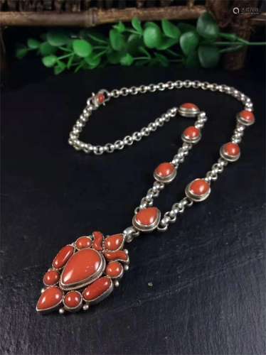 A STRING OF SILVER INLAYED CORAL NECKLACE