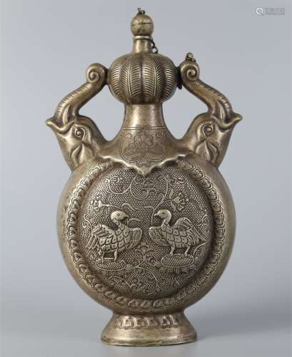 Silver pot decorated with flowers and birds