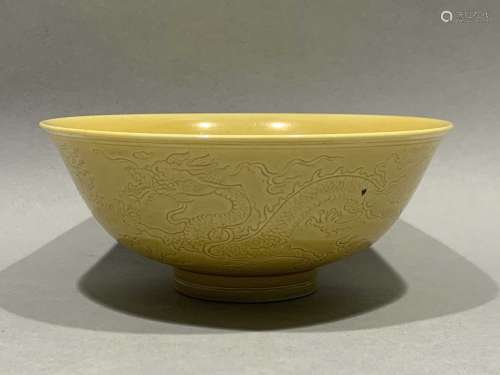 Yellow glazed bowl with dark dragon pattern