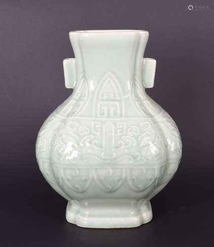 A CARVED CELADON GLAZED PORCELAIN DOUBLE-EARED VASE