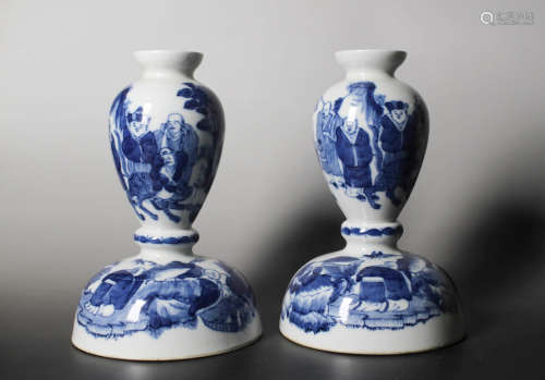 A PAIR OF BLUE AND WHITE ARHAT PORCELAIN CANDLESTICKS