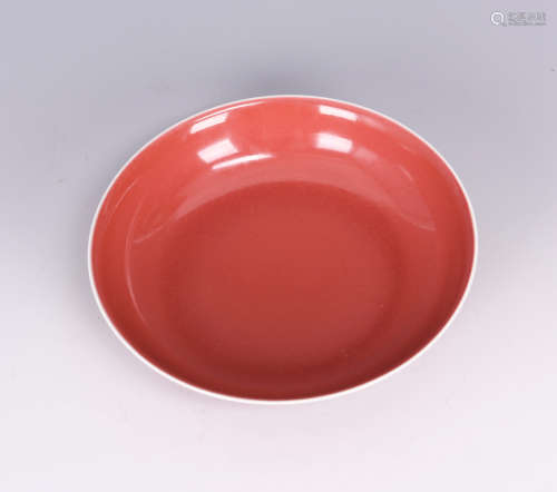 A RED GLAZED PORCELAIN PLATE