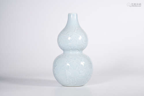 A CELESTE GLAZED CARVED PORCELAIN GOURD-SHAPED VASE