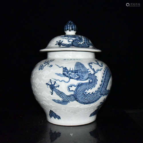 A BLUE WHITE DRAGON CARVED PORCELAIN JAR WITH COVER