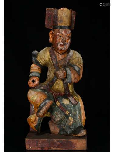 A WOODEN CARVED FIGURE