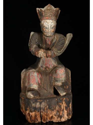A WOODEN CARVED FIGURE