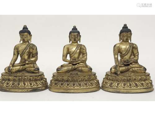 THREE GILT-BRONZE FIGURES OF BUDDHA