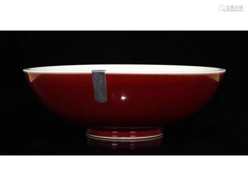 A LARGE RED GLAZED BOWL