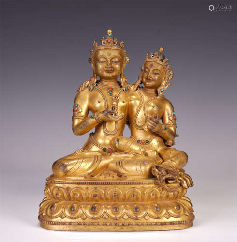 A CHINESE GILT BRONZE BUDDHIST GUARDIAN SEATED STATUE