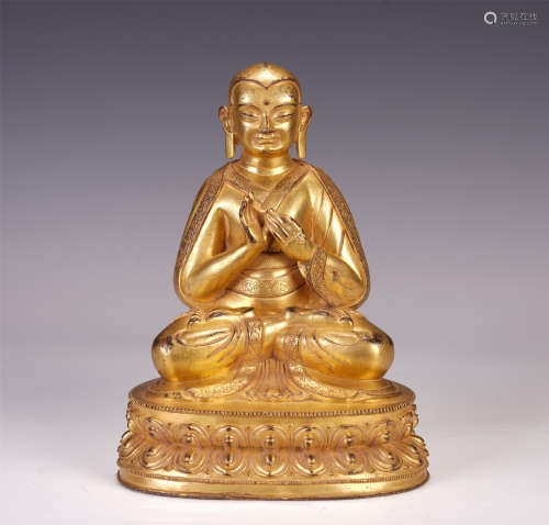 A CHINESE GILT BRONZE GURU SEATED STATUE