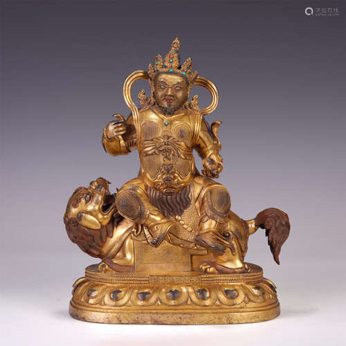 A CHINESE GILT BRONZE BUDDHIST GUARDIAN SEATED STATUE