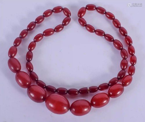 A CHERRY AMBER TYPE BEAD NECKLACE. 56 grams. 68 cm