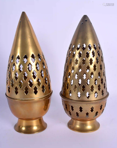 AN UNUSUAL PAIR OF INDIAN BRASS CANDLESTICKS AND