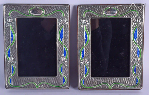 A PAIR OF SILVER AND ENAMEL PHOTOGRAPH FRAMES. 19 cm x