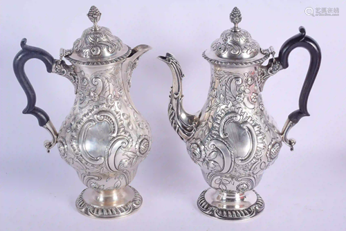 A MATCHED PAIR OF EDWARDIAN SILVER COFFEE POTS. L…