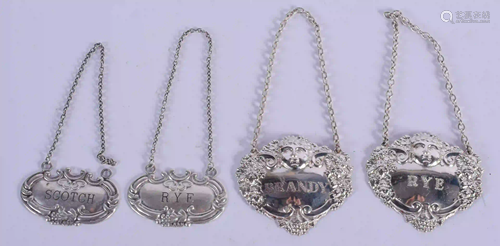 FOUR SILVER DECANTER LABELS. (4)