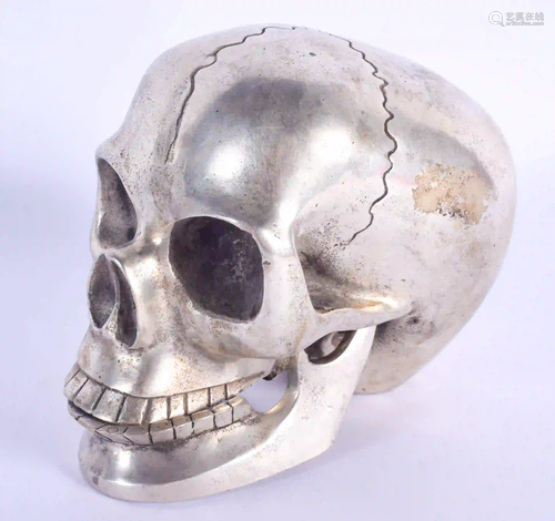 A CONTEMPORARY SILVER PLATED SKULL. 11 cm x 9 cm.