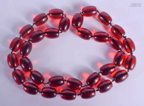 A CHERRY AMBER TYPE NECKLACE. 206 grams. 94 cm long,