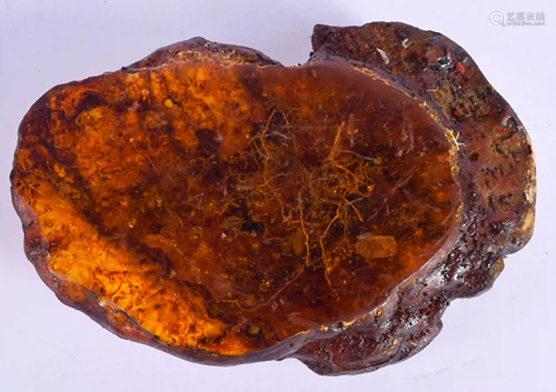 A CONTINENTAL CARVED AMBER NATURALISTIC BOULDER. 481