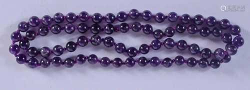 A STRING OF AMETHYST BEADS. 55 grams. 70 cm long.