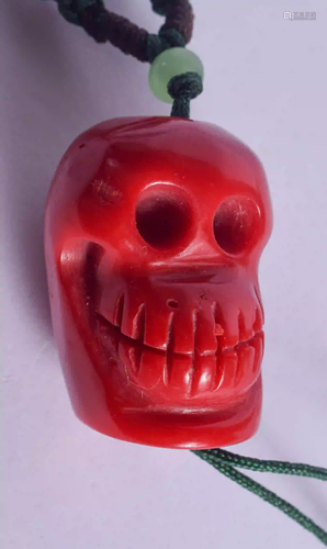 A CHINESE CORAL SKULL NECKLACE. 2.5 cm long.