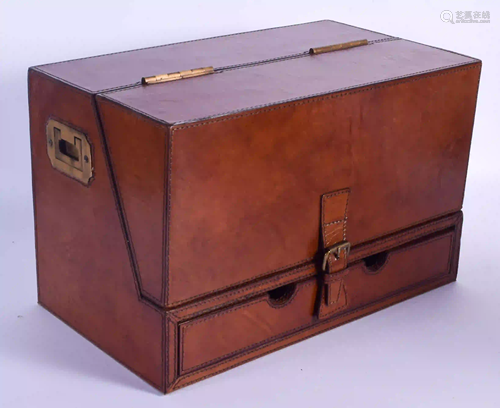 A EUROPEAN LEATHER STATIONARY BOX with brass handles.