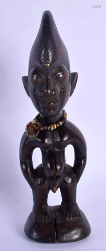 AN AFRICAN TRIBAL YORUBA HARDWOOD FIGURE. 22.5 cm high.