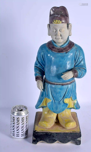 A LARGE CHINESE BLUE GLAZED FIGURE OF A STANDING M…