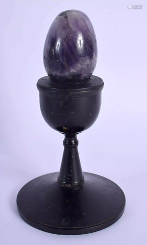 A BLUEJOHN AMETHYST EGG upon a stand. 12 cm high.