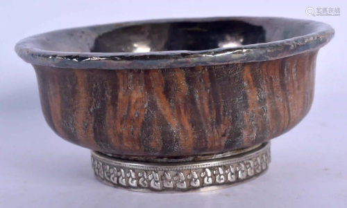 A 19TH CENTURY CHINESE TIBETAN CARVED WOOD AND SILVER