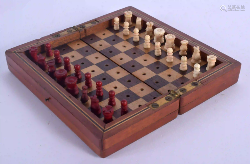AN ANTIQUE CARVED AND STAINED BONE TRAVELLING CHESS