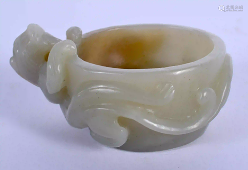 AN EARLY 20TH CENTURY CHINESE CARVED GREEN JADE