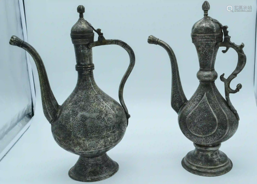 Two Middle Eastern metal embossed Ewers