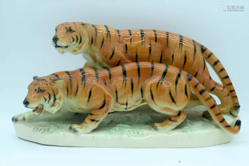A German porcelain figure of two tigers 43 x 18cm.