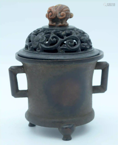 A 19th century bronze incense burner with a carved