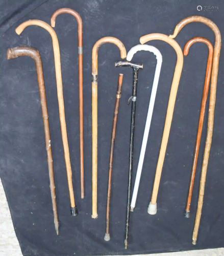Collection of wooden and metal walking sticks 106cm