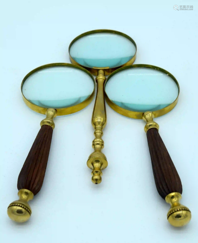 Three vintage magnifying glasses 29cm . (3)