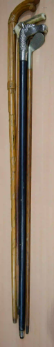 A white metal horse head walking cane together with