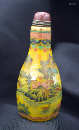 A Chinese glass snuff bottle decorated with mountains