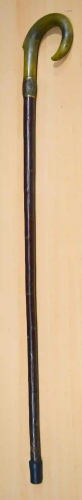 A Rhino horn handled walking cane with a yellow metal