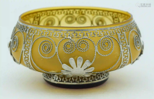 A small Middle Eastern glass bowl with white metal