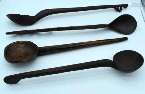 A group of large carved wooden tribal spoons 64 cm