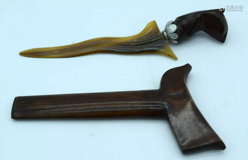 A small horn handled Kris dagger with a wooden handle