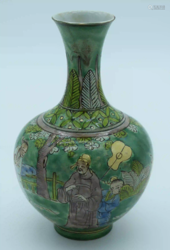 A Chinese green glaze vase decorated with kite flyers