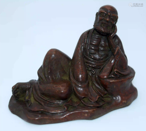 A Japanese small bronze figure of a reclining male