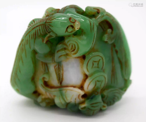 A carved jade bolder decorated with foliage and